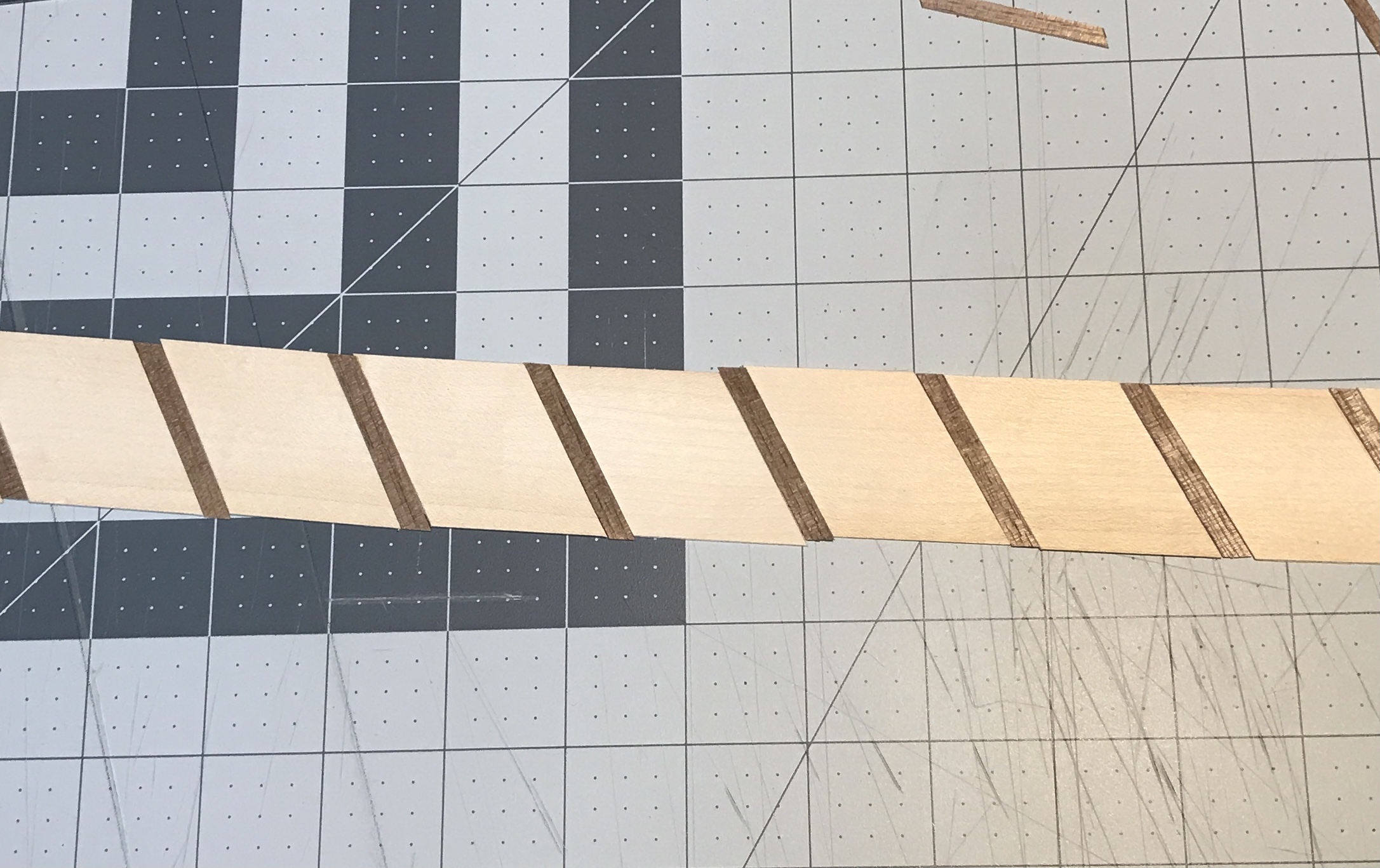 The separator strip laid out with alternating dark and light wood.